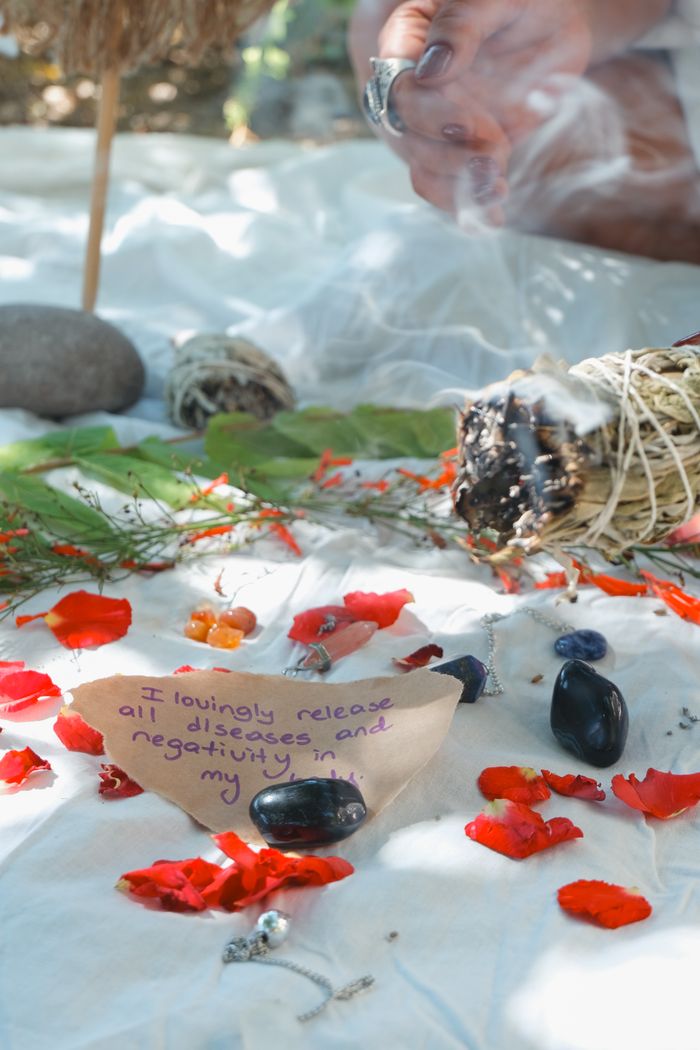 creative-03 A calming ritual space with burning sage, crystals, and a handwritten note promoting healing energy.